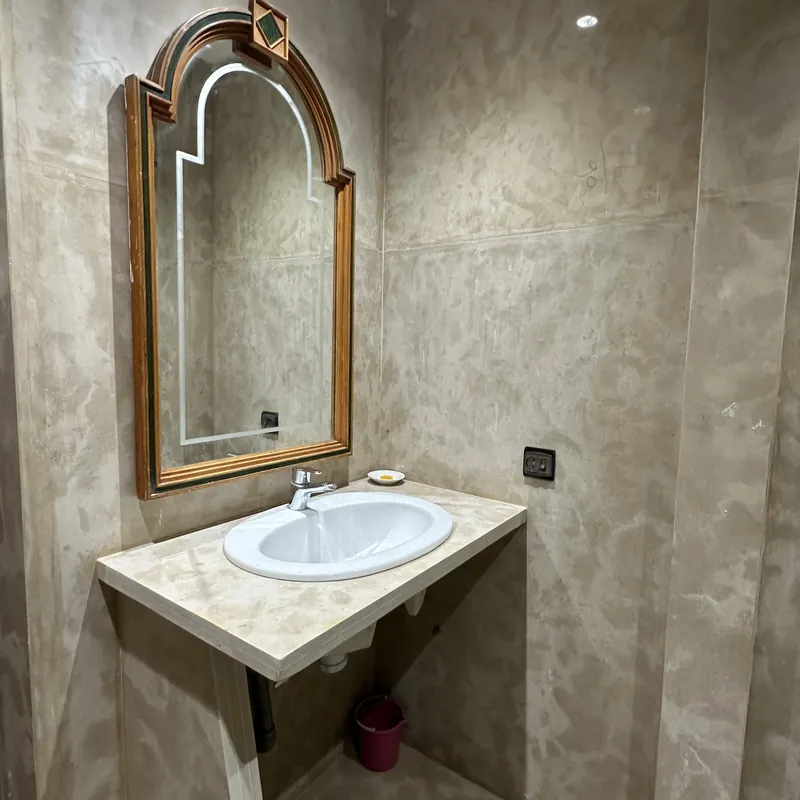 Tadelakt bathroom with hand-carved mirror
