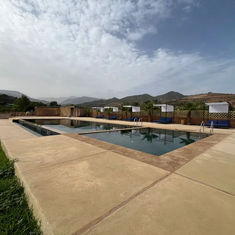 Outdoor swimming pool and lawn with Atlas mountain views