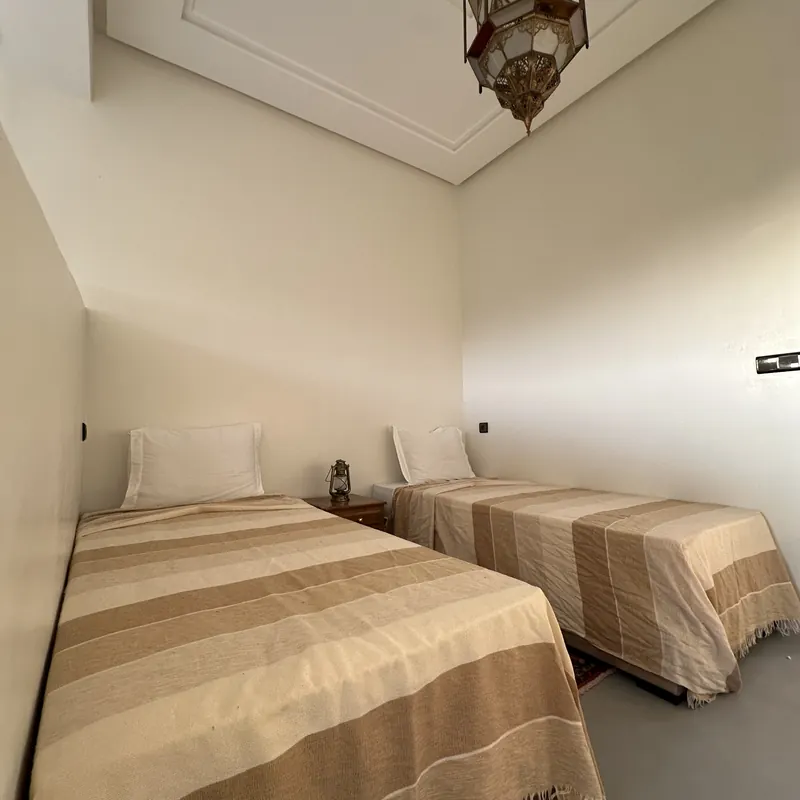 Twin room with Moroccan lantern and hand-woven rugs