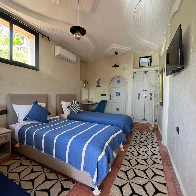 Twin room with blue textiles and patterned floor