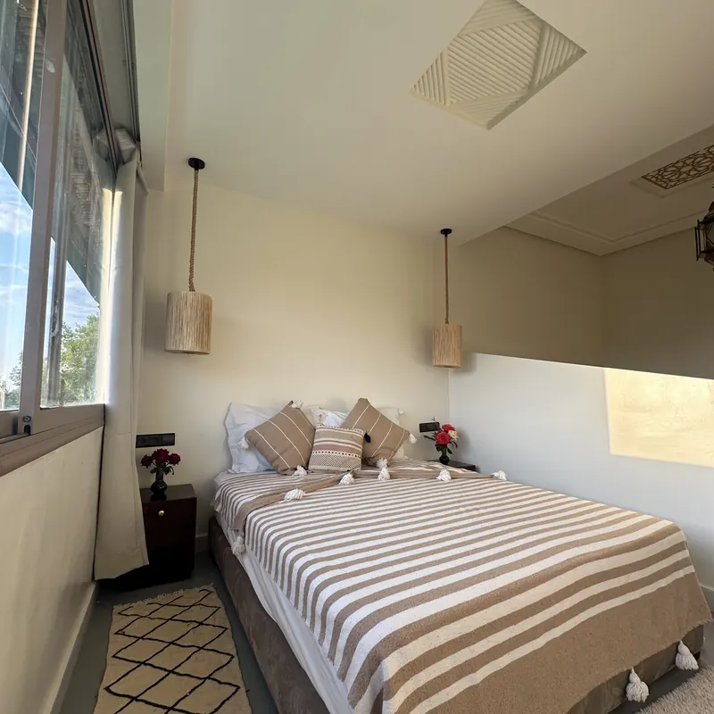 Guest room with pendant lighting and garden views