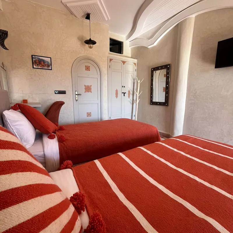 Twin room in warm terracotta tones